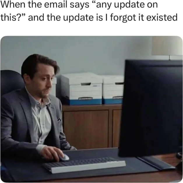 Staring at the screen hoping it disappears. Man at desk looking confused and concerned while staring at computer monitor. Text: When the email says "any update on this?" and the update is I forgot it existed