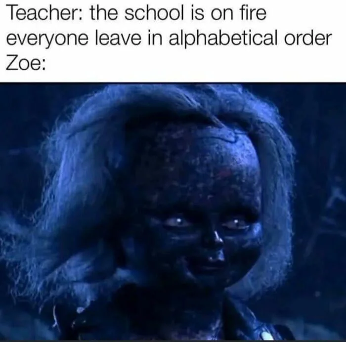 Character with glowing eyes in darkness, implying satisfaction at being first alphabetically. Text: Teacher: the school is on fire everyone leave in alphabetical order Zoe: