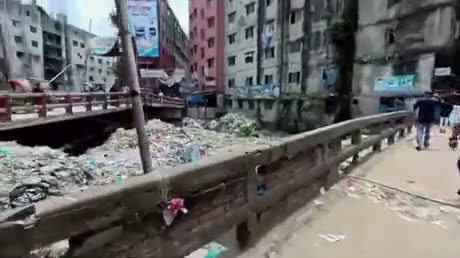 Urban street scene showing construction debris, multi-story…