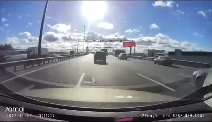 Dashboard camera footage of a highway with multiple vehicles and…