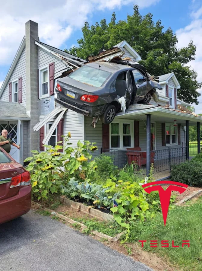 The sky's the limit. A car crashed through the roof of a house, with the Tesla logo visible in the foreground. Text: TESLA