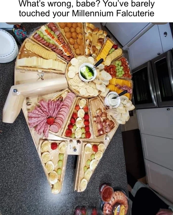 I’m not sharing!. Overhead view of a charcuterie board arranged in the shape of the Millennium Falcon spacecraft from Star Wars. Text: What's wrong, babe? You've barely touched your Millennium Falcuterie