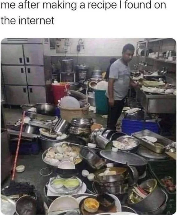 A cluttered kitchen with numerous pots, pans, and dishes scattered everywhere after cooking. Text: me after making a recipe I found on the internet