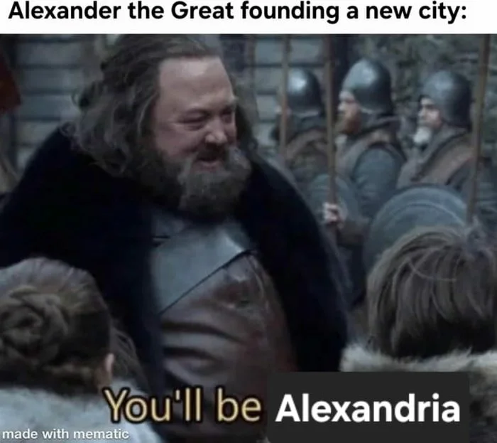 The lazy conqueror's naming strategy. A bearded man in medieval clothing addresses a crowd, announcing the name of a newly founded city. Text: Alexander the Great founding a new city: / You'll be Alexandria