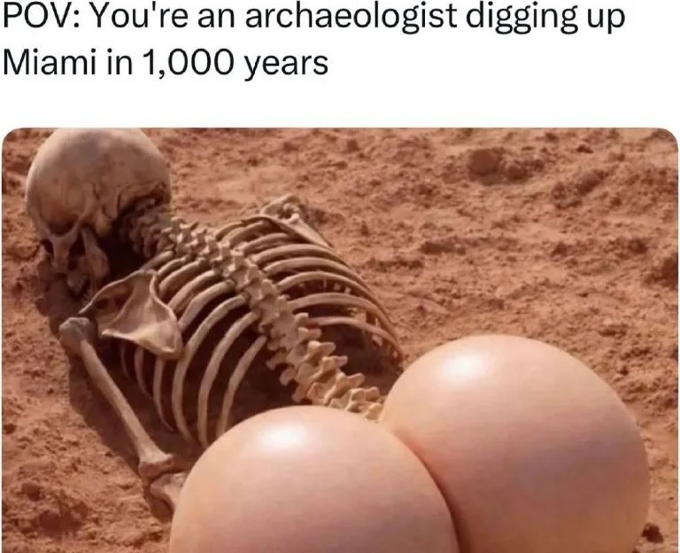 Skeleton remains partially buried in sand with modern silicone implants visible, humorous commentary on future archaeology. Text: POV: You're an archaeologist digging up Miami in 1,000 years