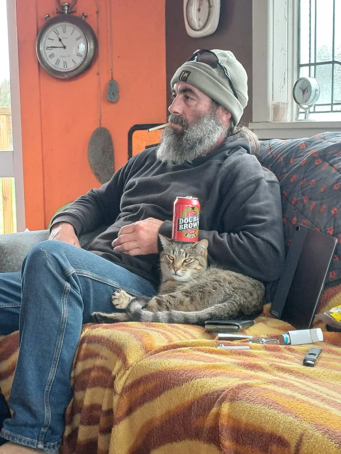 Beer cat !. Bearded man sitting on couch holding beer can with cat nestled on his lap. Text: DOUBLE BROWN