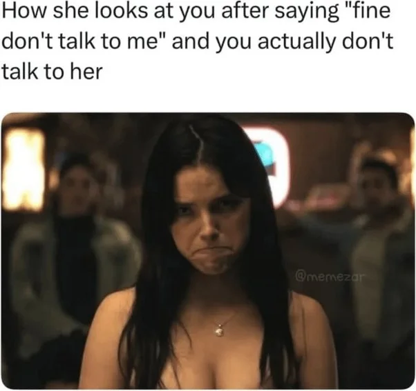 The silent treatment stare. Woman with a serious, disappointed expression looking directly at camera in a crowded setting. Text: How she looks at you after saying "fine don't talk to me" and you actually don't talk to her / @memezar